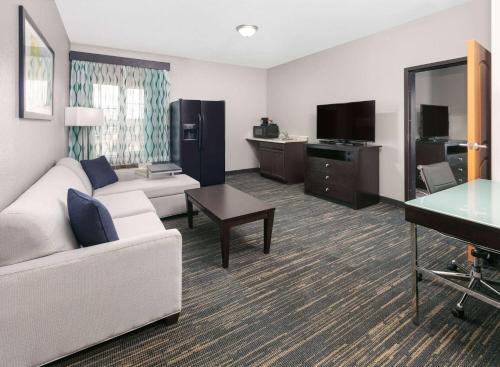 a living room with a couch and a television at La Quinta by Wyndham Little Rock - Bryant in Bryant