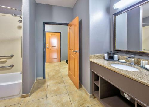 a bathroom with two sinks and a mirror at La Quinta by Wyndham Little Rock - Bryant in Bryant