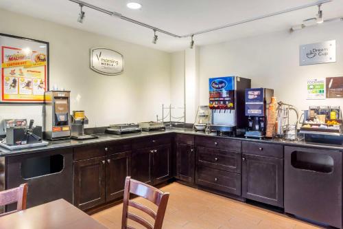 a coffee shop with a counter and a table and chairs at Sleep Inn Sea Tac Airport in SeaTac