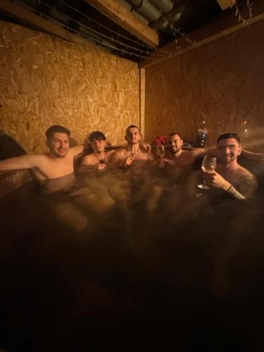 a group of men sitting in a bath tub at Casa de la Baltă in Rieni