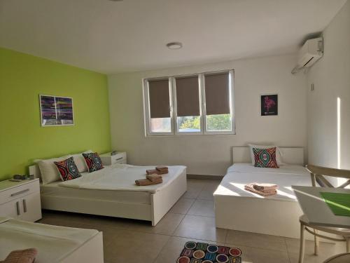 a living room with two beds and a couch at Flamingo Resort in Belgrade