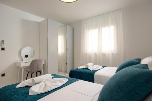 a hotel room with two beds and a mirror at Apartman Palma and Luxury Penthouse for a family with swiming pool,parking,terrace,panoramic view at the sea,Podstrana in Podstrana