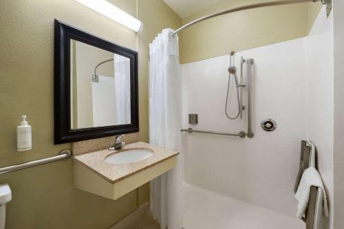 a bathroom with a sink and a shower at Hotel Marguerite South Anaheim - Garden Grove, Trademark Collection by Wyndham in Anaheim