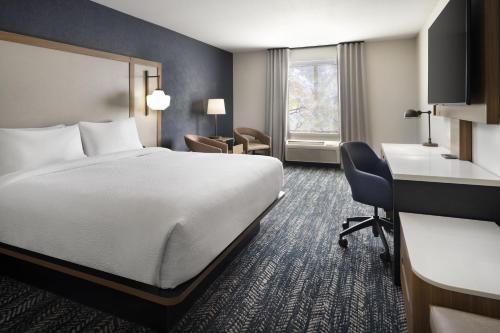 a hotel room with a bed and a desk at Fairfield by Marriott Inn & Suites Fresno Riverpark in Fresno