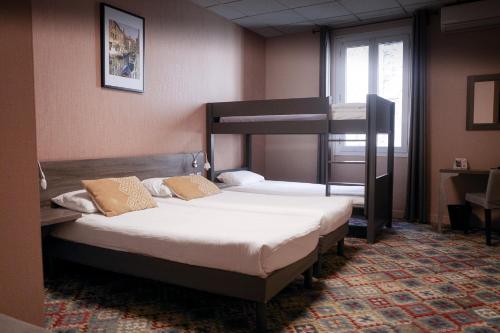 a bedroom with two beds and a bunk bed at The Originals Boutique, Hôtel Danieli, Avignon in Avignon