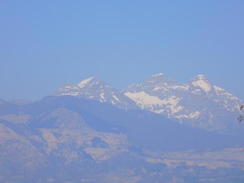 a mountain with a blue lake in front of it at Hotel Residence Sole in Fontanafredda