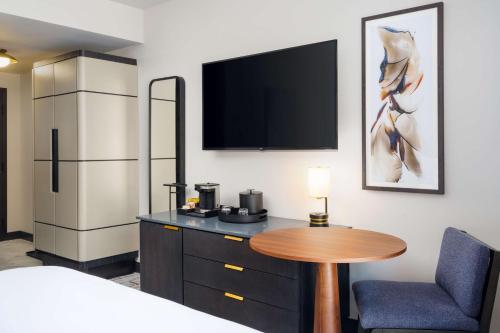 a hotel room with a table and a refrigerator at The Hoffmann Hotel Basalt Aspen Tapestry Collection Hilton in Basalt