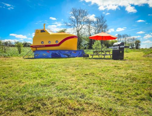 a playground with a slide and an umbrella at The Yellow Submarine in Cheddar