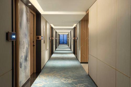a corridor of a hotel with a long hallway at DoubleTree by Hilton Jakarta Bintaro Jaya in Serpong