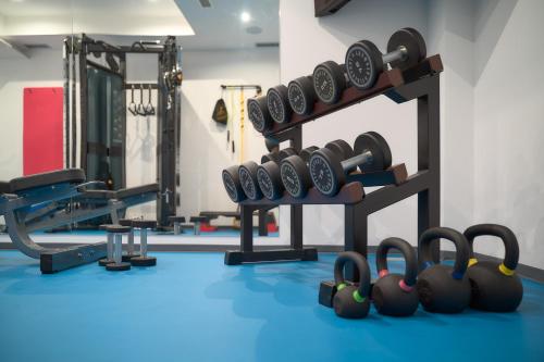 a gym with a bunch of dumbbells on a rack at Villa Žnjan in Split