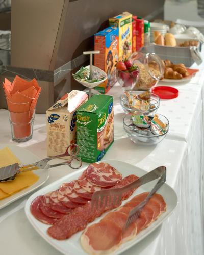 a table topped with plates of meat and other food at Villa Žnjan in Split