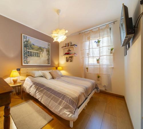 a bedroom with a bed and a television in it at Delma's home in San Daniele del Friuli