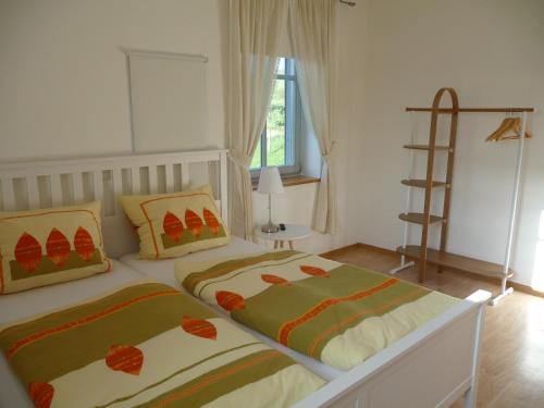 a bedroom with two beds and a book shelf at Gasthof Ziegelhof in Eichenwinden