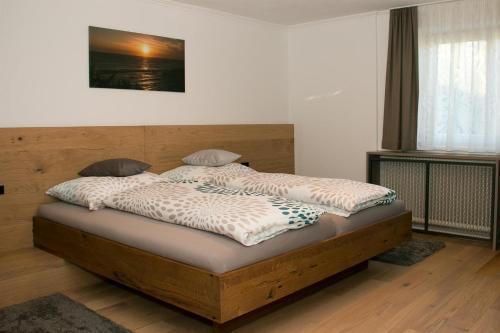 a bed with two pillows on it in a room at Haus Edler in Gleinstätten