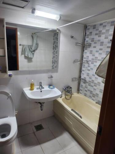 a bathroom with a sink and a toilet and a tub at house for rest in Geoje 