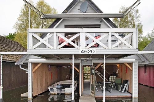 a boat house with a roof on a flooded garage at Bootshaus Am Müritzarm in Vipperow