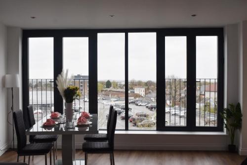a dining room table with a view of a parking lot at Stylish 2BR in Brentwood in Brentwood