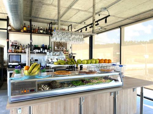 a buffet with fruits and vegetables on a counter at Hospedium Hotel Devalar Do Mar in Camariñas