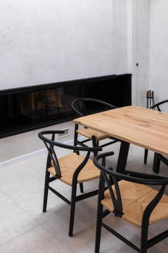 a wooden table and chairs in front of a fireplace at Elysian Fields in Mġarr
