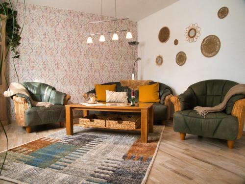a living room with two couches and a coffee table at Ferienwohnung Gute Zeit in Ruhla