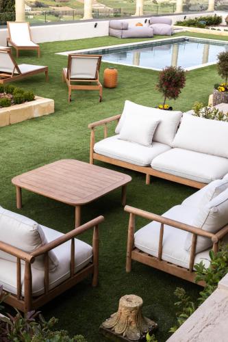 a patio with couches and a table and a pool at Elysian Fields in Mġarr