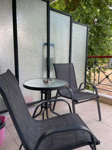 a table and chairs sitting on a patio at Διαμέρισμα με θέα σε πάρκο! in Serres