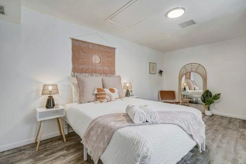 a bedroom with a large bed with two towels on it at Institute Bliss! Newly Remodeled Family Home! in Colorado Springs