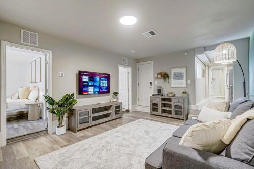 a living room with a couch and a tv at Institute Bliss! Newly Remodeled Family Home! in Colorado Springs