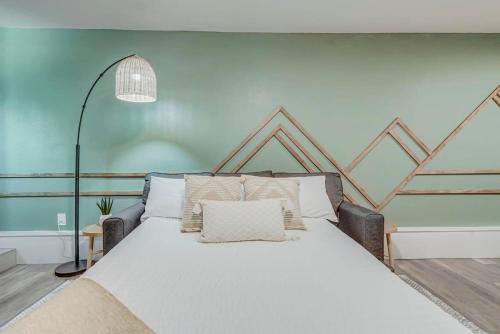 a bedroom with a large white bed with pillows at Institute Bliss! Newly Remodeled Family Home! in Colorado Springs