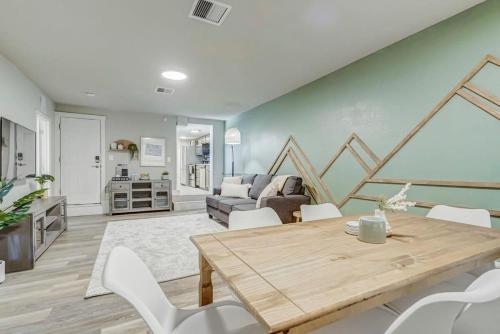 a living room with a wooden table and white chairs at Institute Bliss! Newly Remodeled Family Home! in Colorado Springs