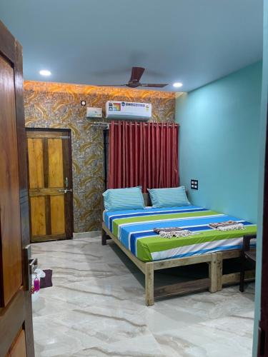 a bedroom with two beds in a room at Nimmu Guest House & Restaurant Gokarna in Gokarna