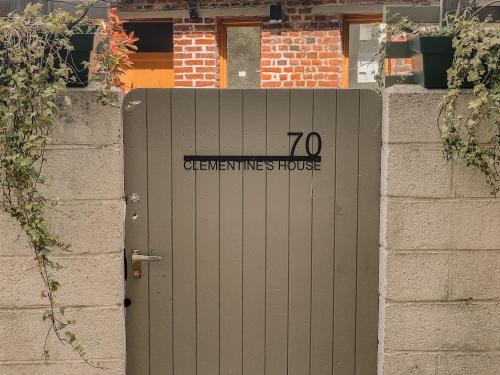 a gray door with the words queens lives house on it at Clementines House Honfleur in Honfleur