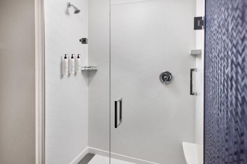 a bathroom with a shower with a glass door at Fairfield by Marriott Inn & Suites Decatur in Decatur