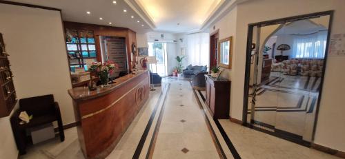 a room with a hallway with a reception desk and a lobby at Hotel Dora in Levanto