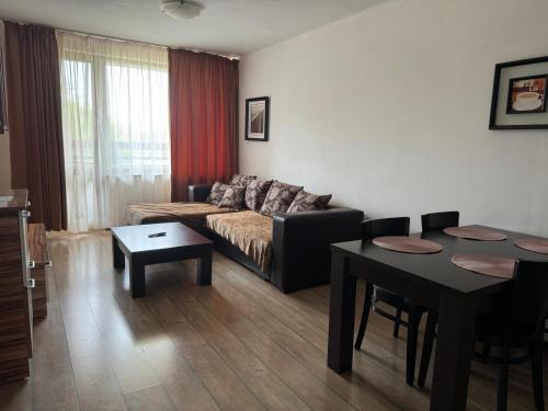 a living room with a couch and a table at Alpine Lodge Bansko Apartments in Bansko