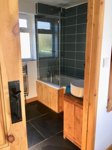 a bathroom with a tub and a sink at Morvoren Cottage in Launceston