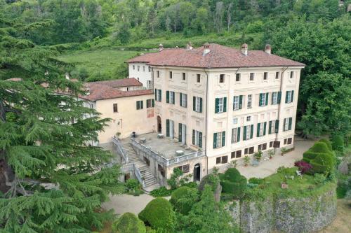 an aerial view of a large white house with trees at Castello Canalis in Cumiana