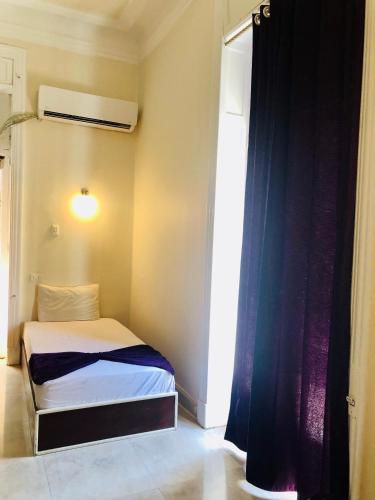 a small bedroom with a bed and a window at OH! Cairo Pharaoh Hostel in Cairo