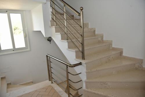 a staircase with a metal railing and a window at Vila Merkuri in Vlorë