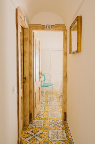 a hallway with a tile floor and an open door at Villa Principe Giovanni in Positano