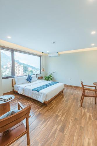 a bedroom with a bed and a large window at Sapa Yen Hotel in Sa Pa