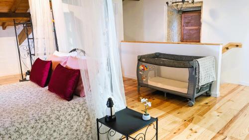 a living room with a bed and a fireplace at Lagarto Pintado Casa n'Aldeia in Castelo Novo