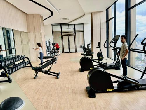 a gym with people exercising on treadmills at Axon Residence By TS in Kuala Lumpur