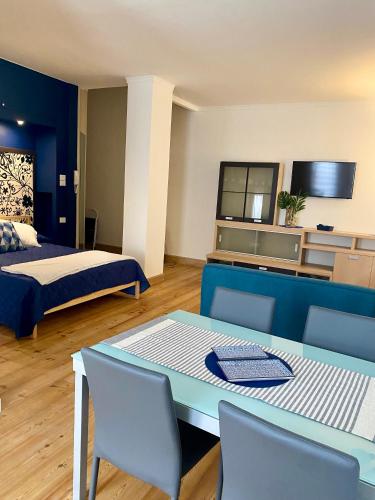 a room with a bed and a table and chairs at Blue Suite in Vicenza