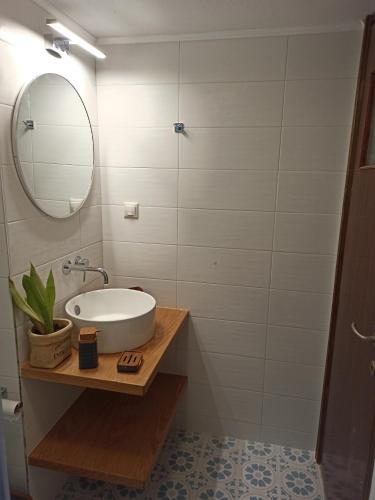 a bathroom with a sink and a mirror at Panos Apartment in Almyrida