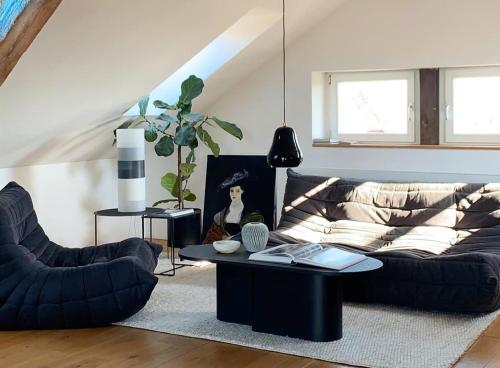 a living room with a couch and a coffee table at Design Apartments "Hier war Goethe nie" in Weimar