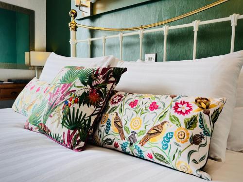 a bed with two pillows on top of it at The Kendrick Exclusively for adults in Llandudno