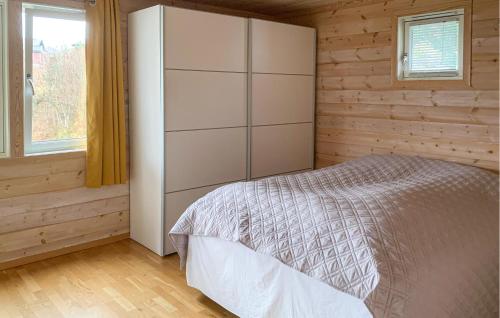 a bedroom with a bed in a wooden cabin at 4 Bedroom Amazing Home In Lindesnes in Eigeland