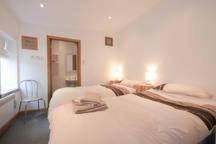 a hotel room with two beds and a window at Ingleside Cottage in Elie