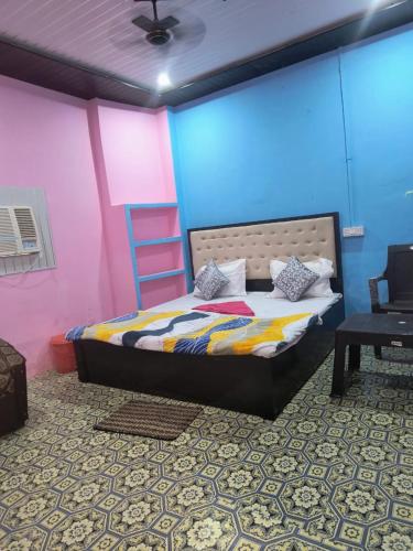 a bedroom with a bed and a pink and blue wall at Goroomgo Rainbow Residency Varanasi Near By Assi Ghat River - Excellent Service in Varanasi